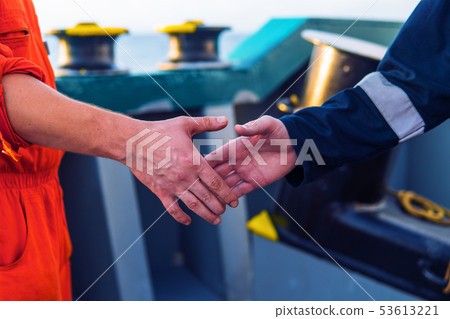 marine contractor businessman handshaking with worker on the ship. 53613221