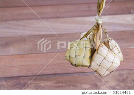 Bunch of ketupat hanging from its weaved palm 53614431