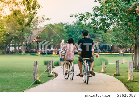 People exercising by cycling in the evening  53620098