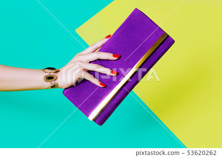 Female hand holding a handbag Female hand holding a handbag 53620262
