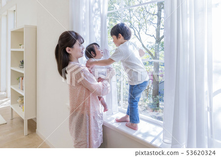 Parent and child playing at the window side Parent and child playing at the window side 53620324