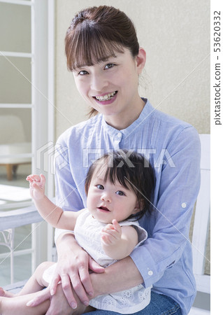 Parents and children sitting on a deck bench 53620332