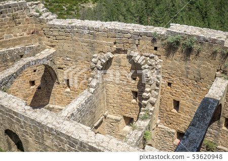 Ruined interior of an ancient medieval castle, part of the half-barrel vault roof 53620948