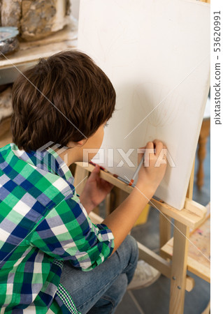 Dark-haired talented schoolboy drawing in the art school Dark-haired talented schoolboy drawing in the art school 53620991