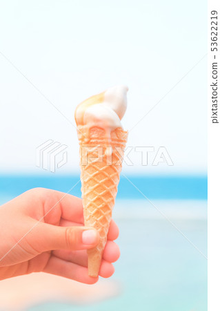Hand holding an ice cream cone Hand holding an ice cream cone 53622219