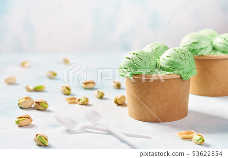 two portions pistachio ice cream in paper cup on 53622854