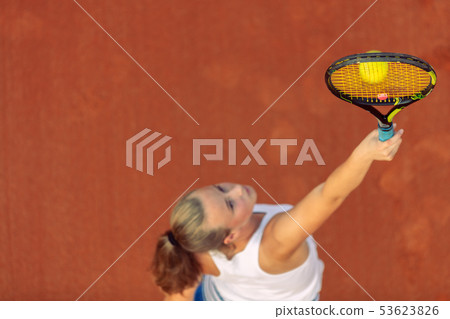 Aerial shot of a female tennis player on a court during match. Young woman playing tennis.High angle 53623826
