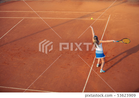 Woman playing tennis on clay court, with sporty outfit and healthy lifestyle Woman playing tennis on clay court, with sporty outfit and healthy lifestyle 53623909