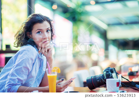 Indoor lifestyle fashion portrait of beautiful woman posing at cafe. Indoor lifestyle fashion portrait of beautiful woman posing at cafe. 53623913