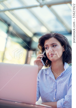 Candid image of a businesswoman working in a cafe. Selective focus. Candid image of a businesswoman working in a cafe. Selective focus. 53623922