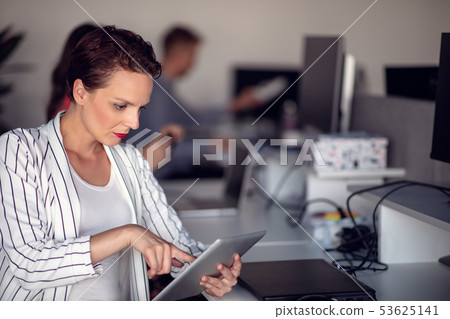 Stylish brunette working from home in her home office 53625141