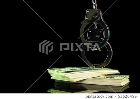 Handcuffs were hung on a dollar banknote in dark. Handcuffs were hung on a dollar banknote in dark. 53626459