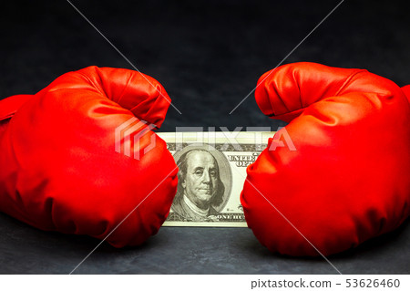 Red boxing gloves holding the dollar banknote. Red boxing gloves holding the dollar banknote. 53626460