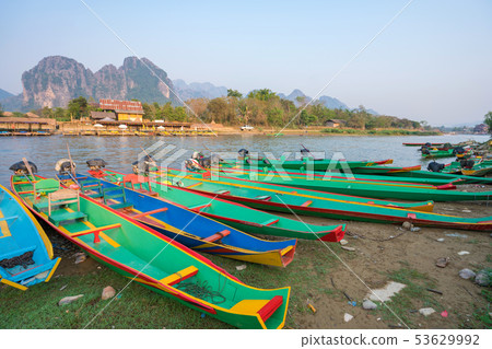 long tail boats on Song river, Vang Vieng Laos long tail boats on Song river, Vang Vieng Laos 53629992