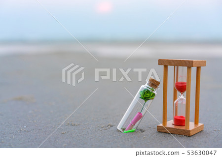 Message or letter in bottle with hourglass  53630047