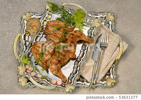 Tobacco chicken on a mirror metal tray served 53631377