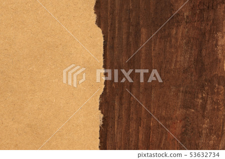 A piece of torn brown kraft paper, shot from the top on a dark rustic wooden background, a grunge A piece of torn brown kraft paper, shot from the top on a dark rustic wooden background, a grunge 53632734