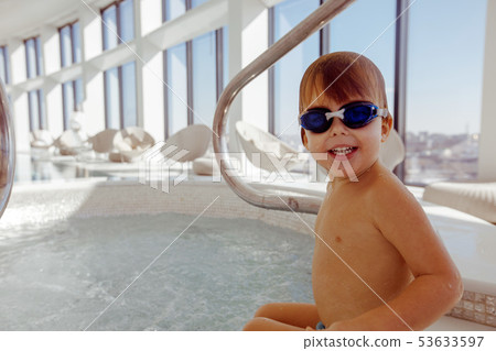 Wet kid in swimming pool 53633597