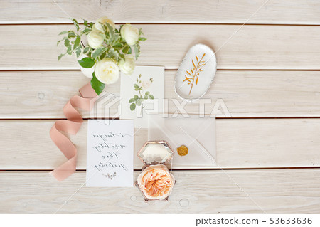 Wedding invitation card with decorations on wood background. Rustic Wedding Overhead view. Flat lay Wedding invitation card with decorations on wood background. Rustic Wedding Overhead view. Flat lay 53633636