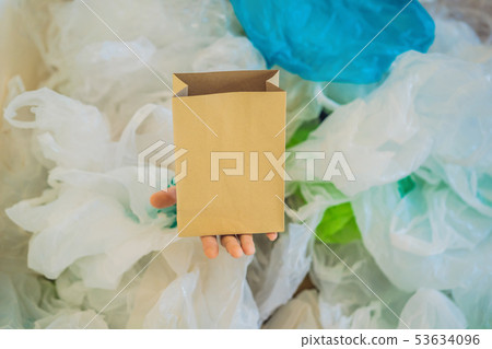 Paper bag amid a pile of plastic bags. Zero waste concept. The concept of World Environment Day 53634096
