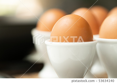 Close up boiled egg in egg cup Close up boiled egg in egg cup 53634140