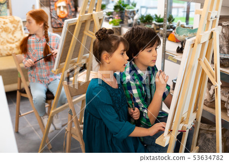 Active children feeling excited while drawing in art school Active children feeling excited while drawing in art school 53634782