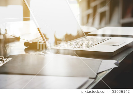 Laptop and papers on desk double exposure 53636142