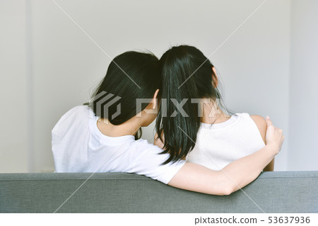 Girlfriends hugging together to encourage. 53637936