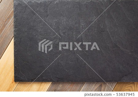 slate stone at wooden background 53637945