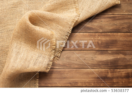 burlap hessian sacking on wooden background 53638377