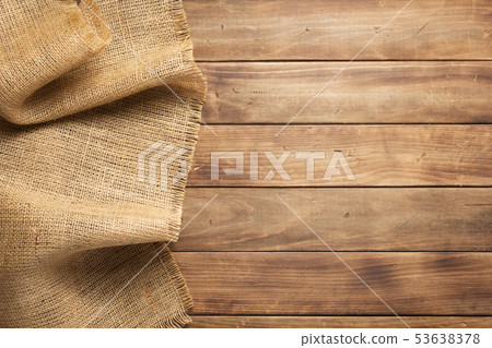 burlap hessian sacking on wooden background 53638378