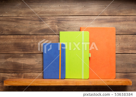 note book or notepad at shelf on wooden background note book or notepad at shelf on wooden background 53638384