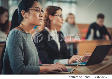 Multinational group of students in an auditorium 53638870