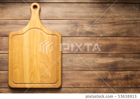 pizza cutting board at wooden plank board 53638913