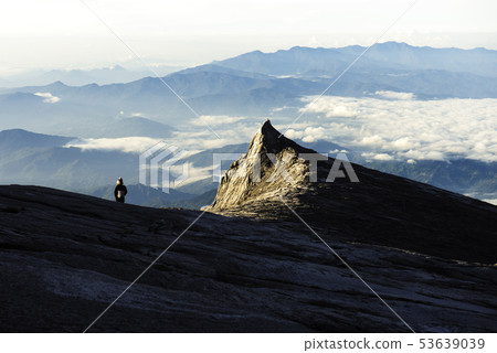 Trekker standing on Kinabalu mountain with south Trekker standing on Kinabalu mountain with south 53639039