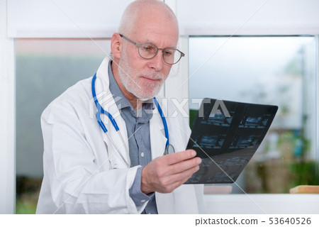 Mature Doctor looking at an x-ray in  office 53640526