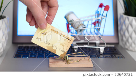 Male hand holding a credit card near the 53640721