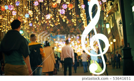 Unrecognizable people walking along beautiful illuminated pedestrian street in the evening 53641651