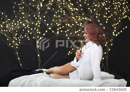Smiling woman in white shit with glass of Smiling woman in white shit with glass of 53643605
