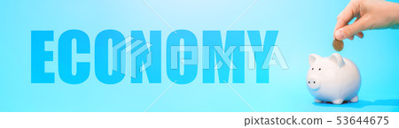 Image of piggy bank , hands with coin and word on blue background Image of piggy bank , hands with coin and word on blue background 53644675