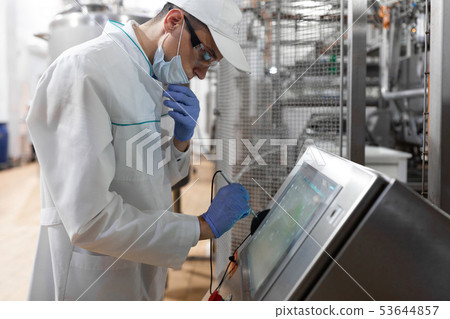 man in a white robe and a cap make a configure the digital screen man in a white robe and a cap make a configure the digital screen 53644857
