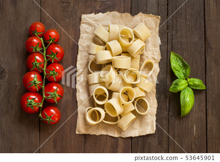 Pasta with tomatoes and basil on wooden background 53645901
