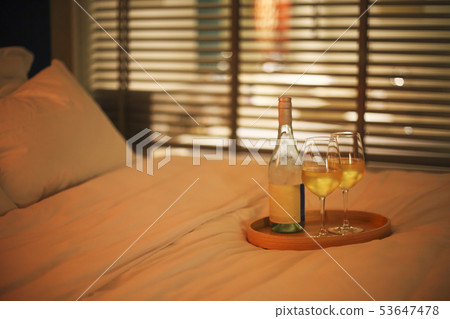 Two glasses of white wine in bed on the blurred Two glasses of white wine in bed on the blurred 53647478