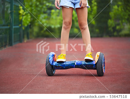 Feet of the little girl riding on a segway Feet of the little girl riding on a segway 53647518