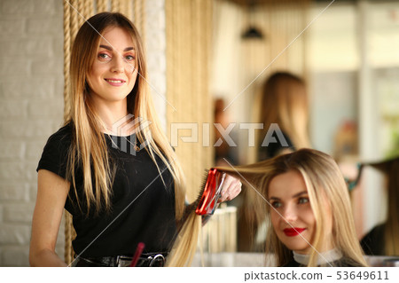 Young Hairdresser Styling Haircut for Girl Client Young Hairdresser Styling Haircut for Girl Client 53649611