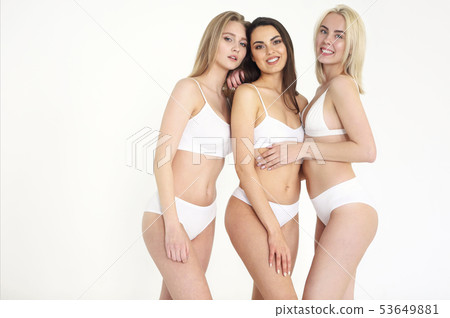 Cheerful young multiethnic women in white lingerie 53649881