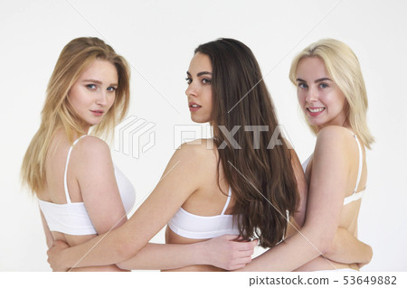 Cheerful young multiethnic women in white lingerie 53649882