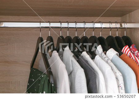 Female different clothes on black wooden hang 53650207