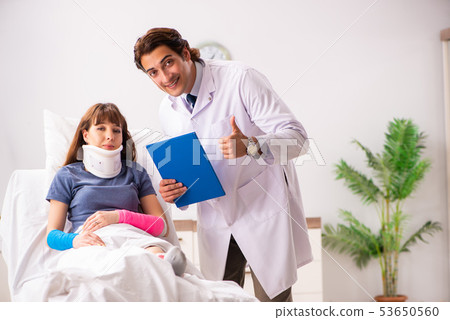 Young doctor examining injured patient Young doctor examining injured patient 53650560