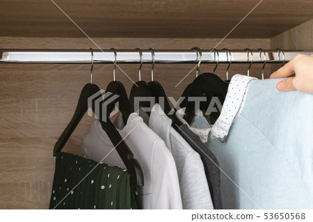 Female hand hangs clothes 53650568